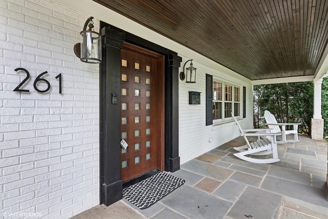 261 Woodstock Ave, Glen Ellyn, IL 60137 - property entrance featuring covered porch and brick siding
