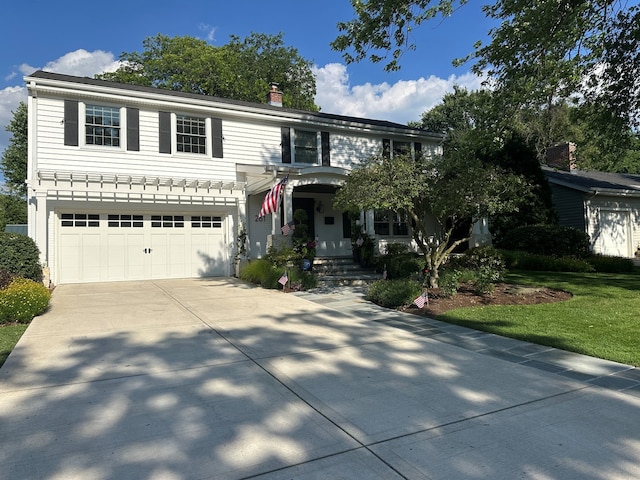261 Woodstock Ave, Glen Ellyn, IL 60137 - traditional-style house with driveway, a garage, and a chimney