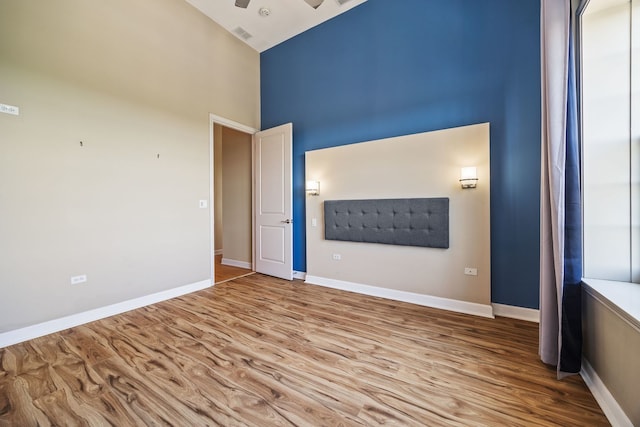 50 N Plum Grove Rd Unit 703E, Palatine, IL 60067 - empty room featuring high vaulted ceiling, wood finished floors, and ceiling fan