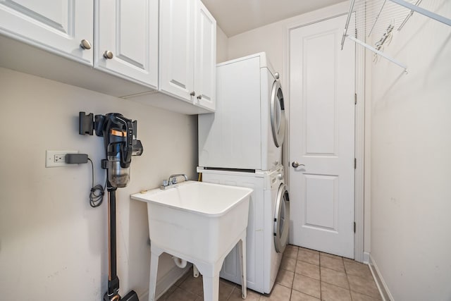 50 N Plum Grove Rd Unit 703E, Palatine, IL 60067 - laundry area with estacked washer and dryer, light tile patterned floors, and cabinet space