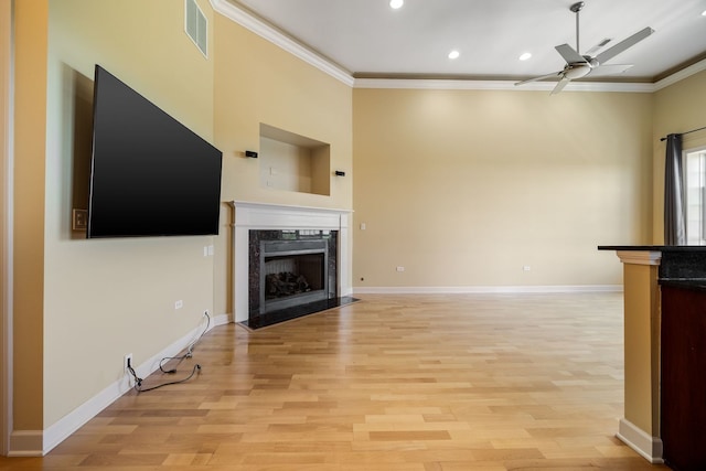 50 N Plum Grove Rd Unit 703E, Palatine, IL 60067 - unfurnished living room with ornamental molding, a premium fireplace, a ceiling fan, recessed lighting, and light wood-style flooring