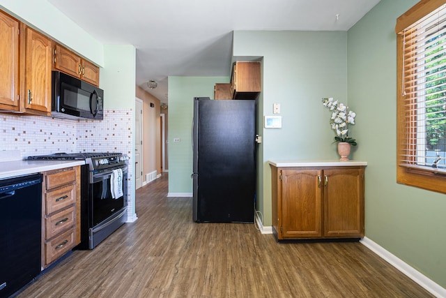 1416 S Chestnut Dr, Mount Prospect, IL 60056 - kitchen with black appliances, dark wood finished floors, decorative backsplash, and brown cabinetry