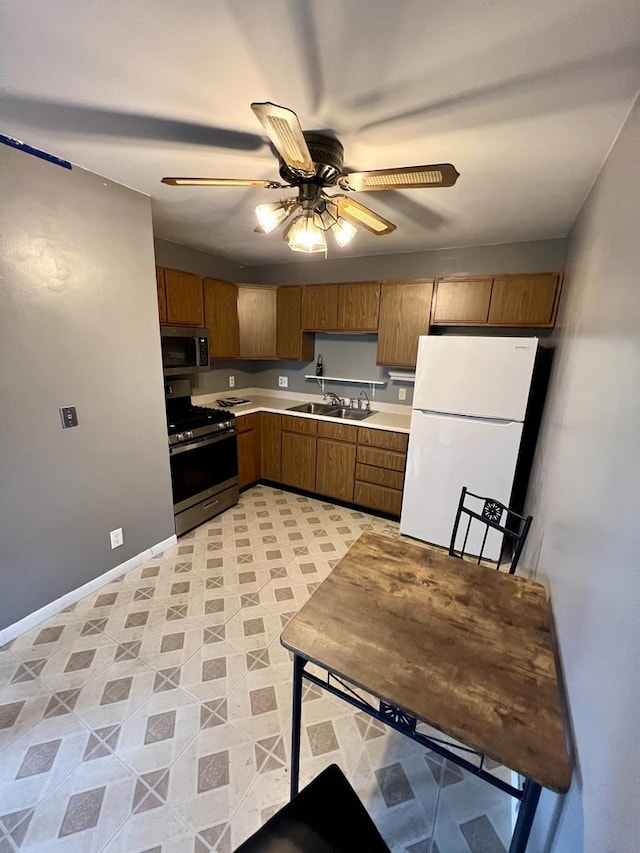 2350 Carnation Dr Unit 4, Crest Hill, IL 60403 - kitchen with stainless steel appliances, light countertops, ceiling fan, and brown cabinetry