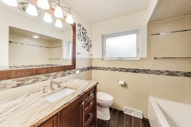 835 Tomawadee Ln, Park Ridge, IL 60068 - bathroom with tile walls, vanity, wood finished floors, and a wainscoted wall