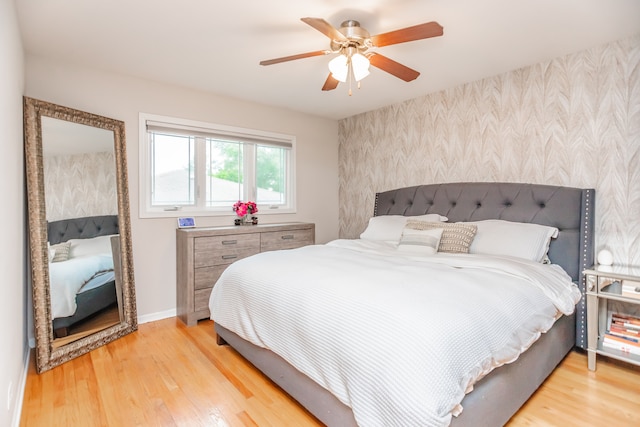 7613 Stratford Pl, Darien, IL 60561 - bedroom featuring wallpapered walls, an accent wall, light wood finished floors, and ceiling fan