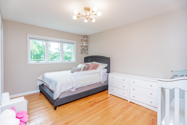 7613 Stratford Pl, Darien, IL 60561 - bedroom with a chandelier and light wood-style floors