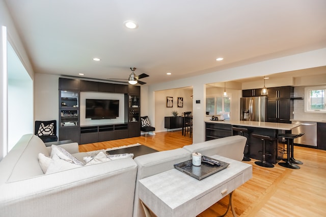 7613 Stratford Pl, Darien, IL 60561 - living room with light wood finished floors, ceiling fan, and recessed lighting
