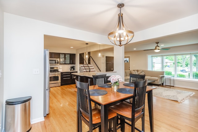 7613 Stratford Pl, Darien, IL 60561 - dining area with light wood finished floors, ceiling fan, a chandelier, and stairway
