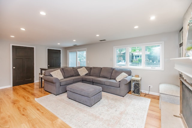 7613 Stratford Pl, Darien, IL 60561 - living room with a fireplace, light wood-style floors, and recessed lighting