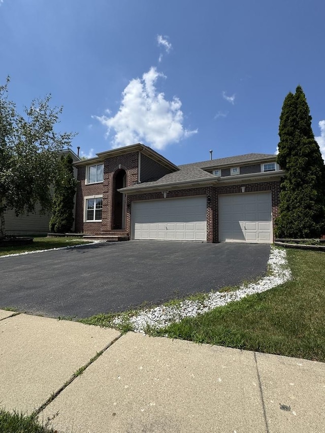 412 Merry Oaks Rd, Streamwood, IL 60107 - view of front of property featuring brick siding, an attached garage, and driveway