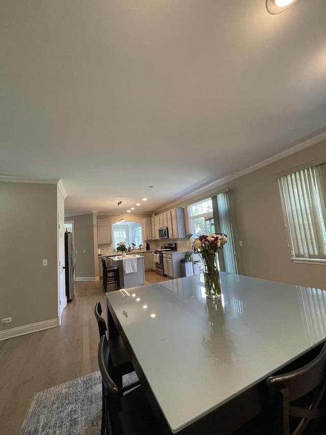 412 Merry Oaks Rd, Streamwood, IL 60107 - dining room with crown molding, light wood-style floors, and recessed lighting