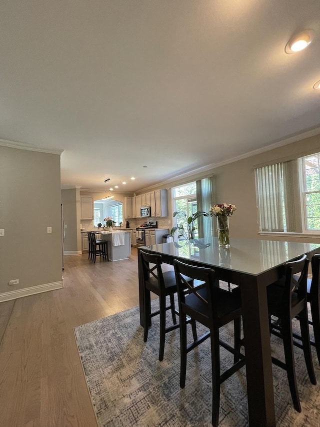 412 Merry Oaks Rd, Streamwood, IL 60107 - dining space featuring ornamental molding, healthy amount of natural light, light wood-style flooring, and recessed lighting