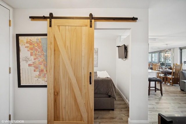 400 E Randolph St Unit 826, Chicago, IL 60601 - corridor with wood finished floors, a barn door, and a chandelier