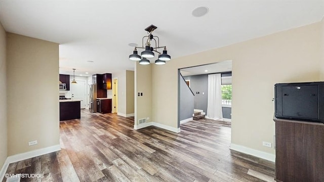 137 Forest Ave, Fox Lake, IL 60020 - unfurnished living room featuring dark wood-style floors, a chandelier, stairway, and recessed lighting