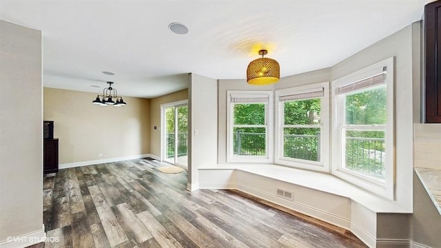 137 Forest Ave, Fox Lake, IL 60020 - unfurnished dining area with wood finished floors and a chandelier