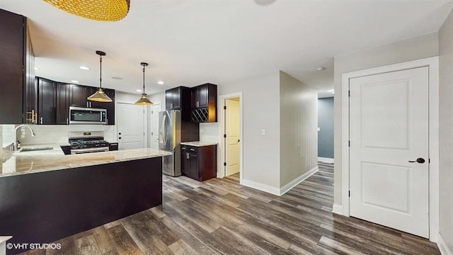 137 Forest Ave, Fox Lake, IL 60020 - kitchen featuring appliances with stainless steel finishes, dark wood-type flooring, dark brown cabinetry, recessed lighting, and pendant lighting
