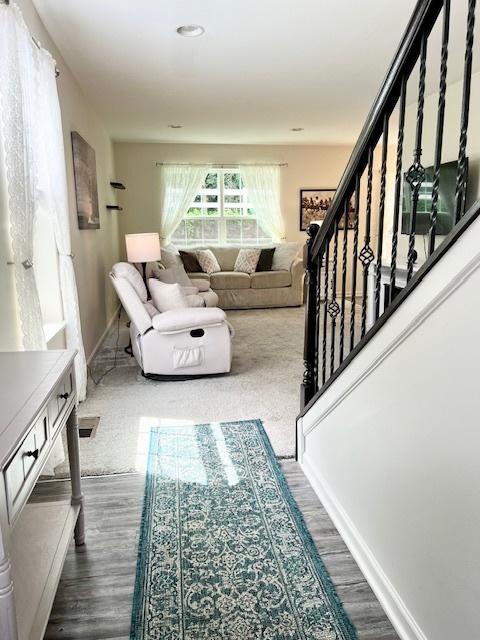 7031 Country Club Hills Dr, Fox Lake, IL 60020 - living room with dark wood-style flooring and stairway