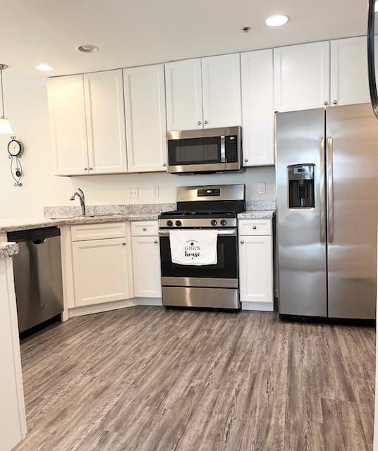 7031 Country Club Hills Dr, Fox Lake, IL 60020 - kitchen with stainless steel appliances, white cabinetry, recessed lighting, and light stone counters