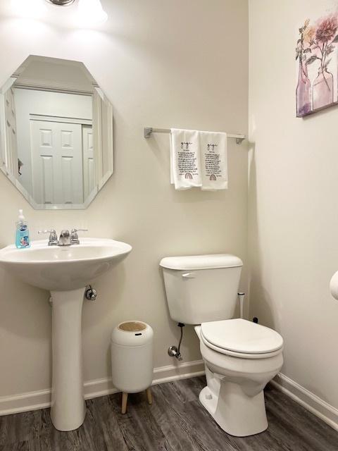 7031 Country Club Hills Dr, Fox Lake, IL 60020 - half bath with wood finished floors and toilet