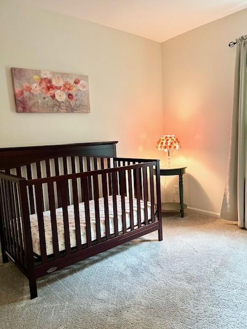 7031 Country Club Hills Dr, Fox Lake, IL 60020 - carpeted bedroom with baseboards and a nursery area