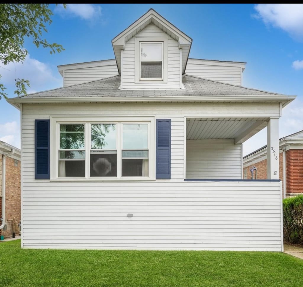3516 N Neenah Ave, Chicago, IL 60634 - view of front facade featuring a front lawn and a shingled roof