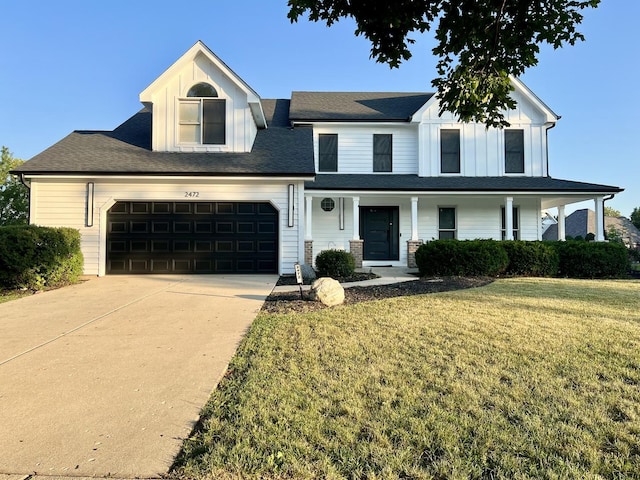 2472 Worthington Dr, Aurora, IL 60506 - view of front of house with a front yard, driveway, covered porch, board and batten siding, and a garage