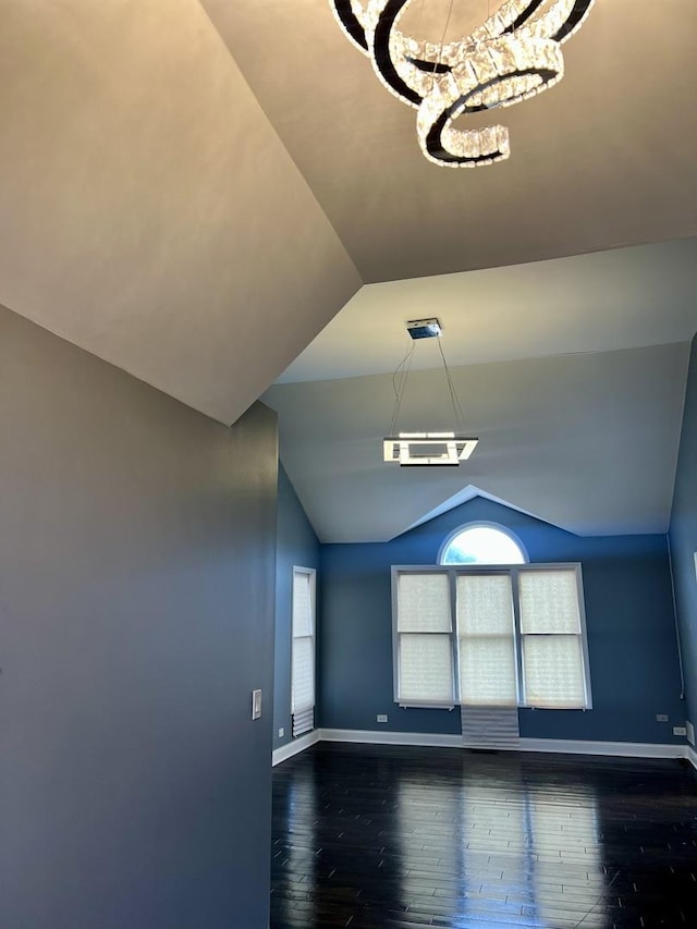 2472 Worthington Dr, Aurora, IL 60506 - unfurnished room with dark wood-style floors, lofted ceiling, a chandelier, and healthy amount of natural light