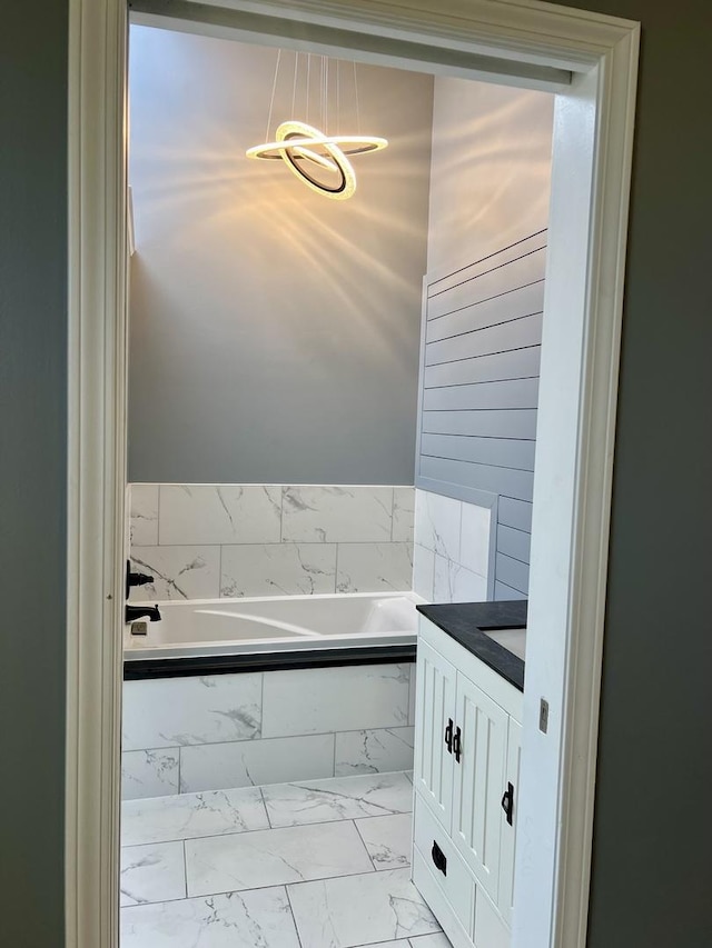 2472 Worthington Dr, Aurora, IL 60506 - full bath with marble finish flooring, a bath, vanity, and a chandelier