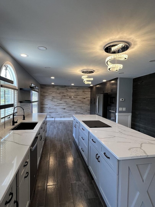 2472 Worthington Dr, Aurora, IL 60506 - kitchen with black appliances, dark wood-style floors, light stone countertops, a large island, and recessed lighting