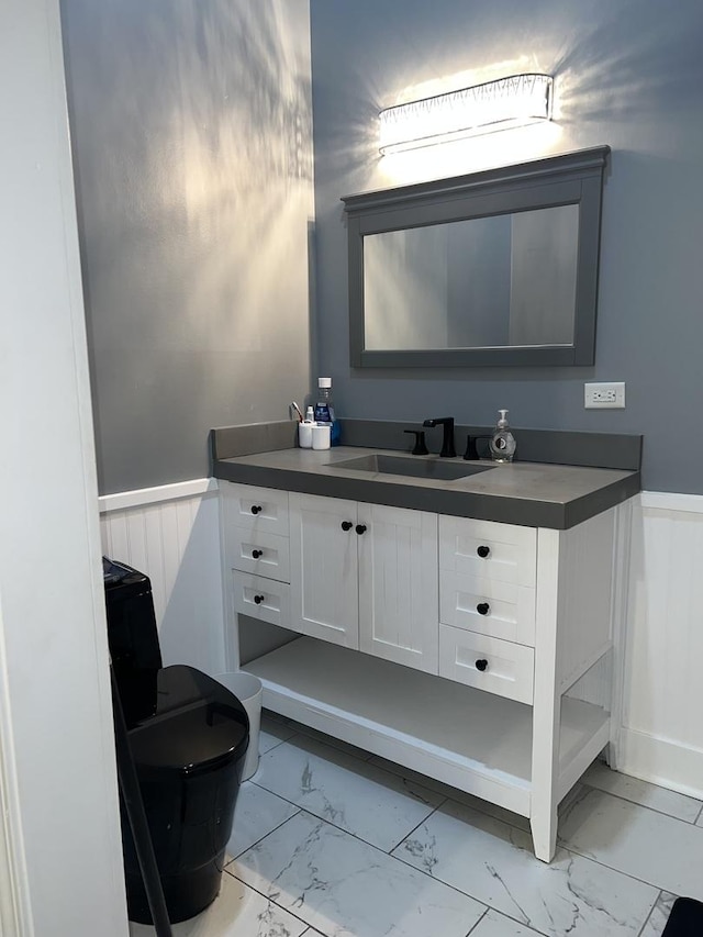 2472 Worthington Dr, Aurora, IL 60506 - bathroom featuring marble look tiles, a wainscoted wall, and vanity