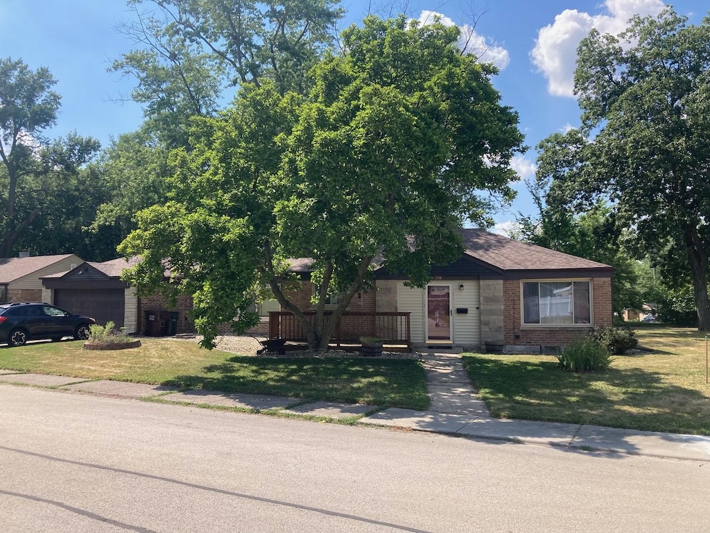 308 Oswego St, Park Forest, IL 60466 - view of front of house featuring brick siding, a front lawn, and a garage