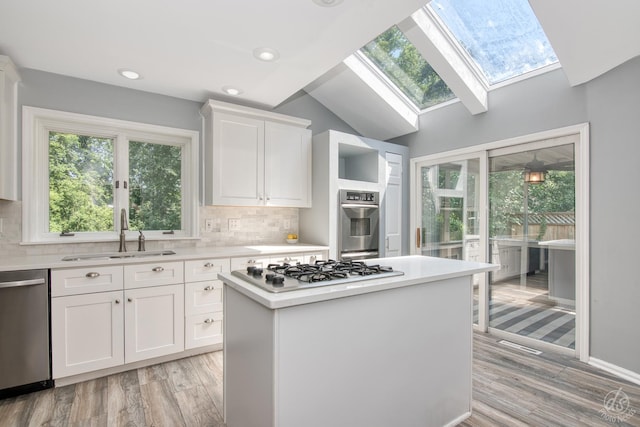 28426 W Lindbergh Dr, Barrington, IL 60010 - kitchen with appliances with stainless steel finishes, a skylight, light countertops, tasteful backsplash, and lofted ceiling