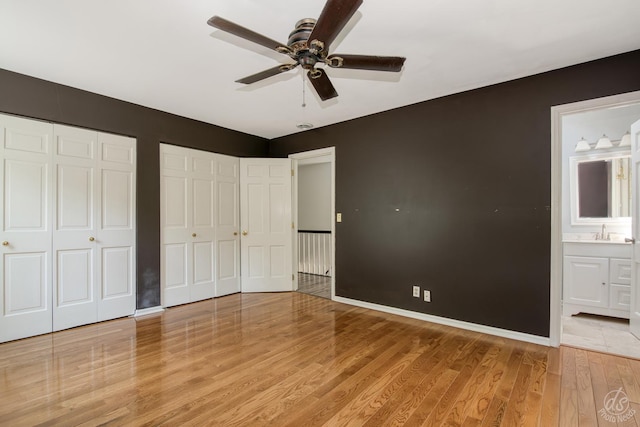 28426 W Lindbergh Dr, Barrington, IL 60010 - unfurnished bedroom featuring multiple closets, light wood-style flooring, ensuite bathroom, and a ceiling fan