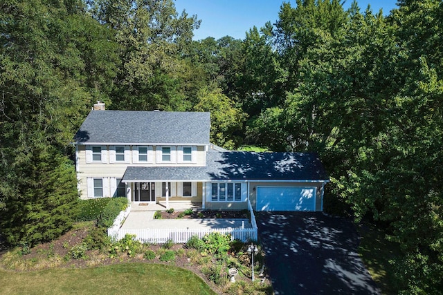 28426 W Lindbergh Dr, Barrington, IL 60010 - view of front of house with an attached garage, asphalt driveway, a chimney, covered porch, and a shingled roof