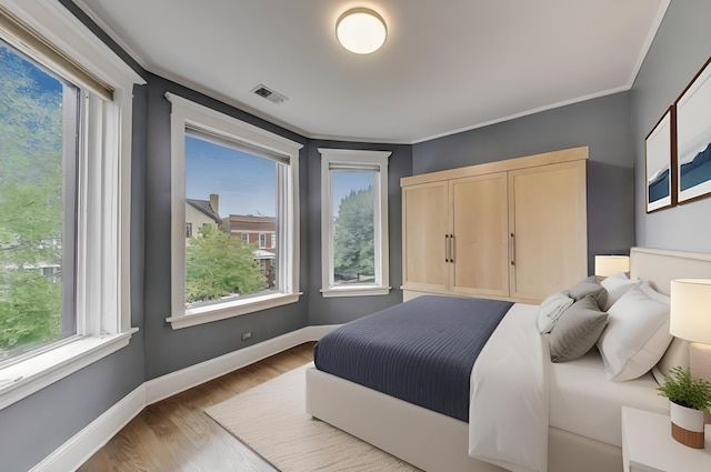 3822 N Claremont Ave, Chicago, IL 60618 - bedroom with wood finished floors and ornamental molding