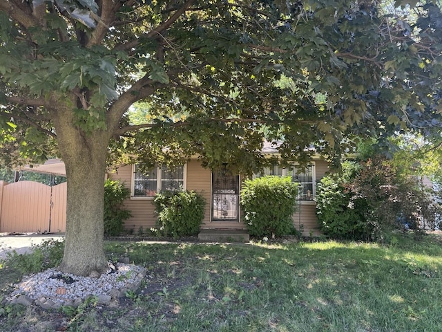 308 Old Indian Trl, Aurora, IL 60506 - view of property hidden behind natural elements with a gate and a front lawn