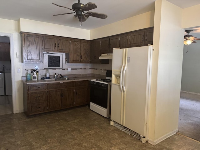 308 Old Indian Trl, Aurora, IL 60506 - kitchen with white appliances, ceiling fan, under cabinet range hood, washer and clothes dryer, and dark brown cabinets