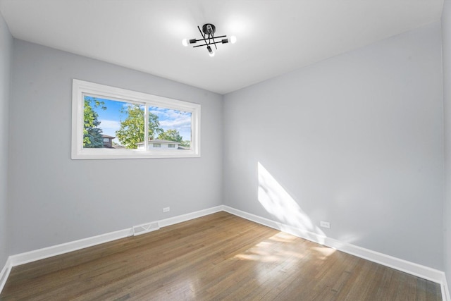 49 Stacy Ct, Glenview, IL 60025 - empty room featuring wood finished floors and a chandelier