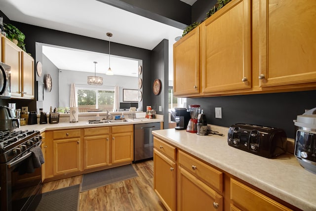 4576 Hilltop Dr, Loves Park, IL 61111 - kitchen with appliances with stainless steel finishes, light wood-style flooring, light countertops, and pendant lighting