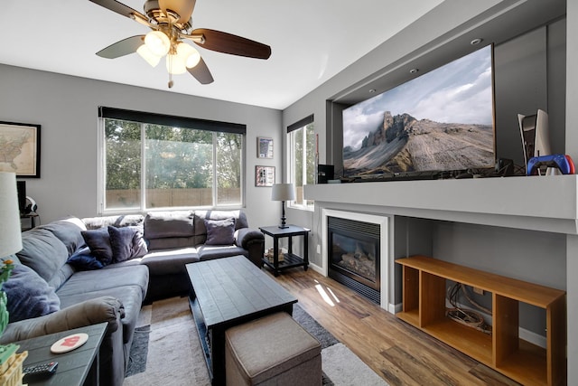 4576 Hilltop Dr, Loves Park, IL 61111 - living room featuring wood finished floors, a ceiling fan, and a glass covered fireplace