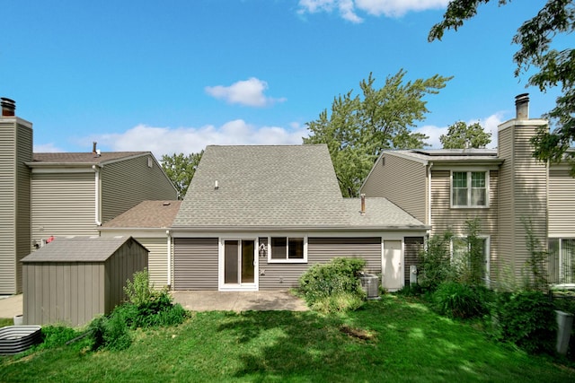 29W409 White Oak Dr, Warrenville, IL 60555 - back of house with a storage shed, a patio area, a yard, and a shingled roof