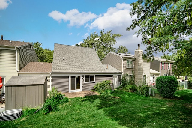 29W409 White Oak Dr, Warrenville, IL 60555 - back of property featuring a storage shed, a yard, and a shingled roof