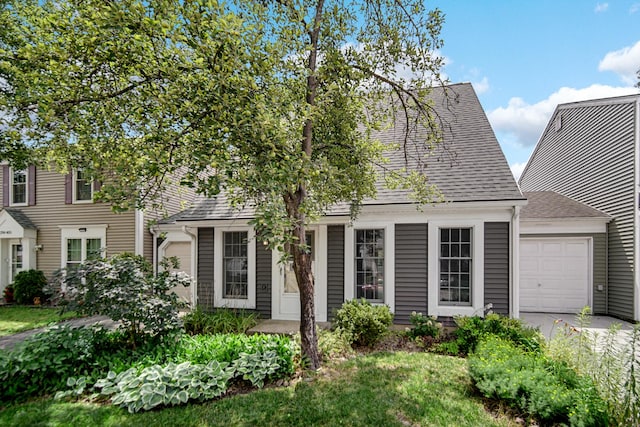29W409 White Oak Dr, Warrenville, IL 60555 - view of front facade featuring roof with shingles, an attached garage, and driveway