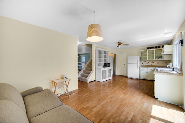 29W409 White Oak Dr, Warrenville, IL 60555 - living room featuring light wood-type flooring, a ceiling fan, and stairway