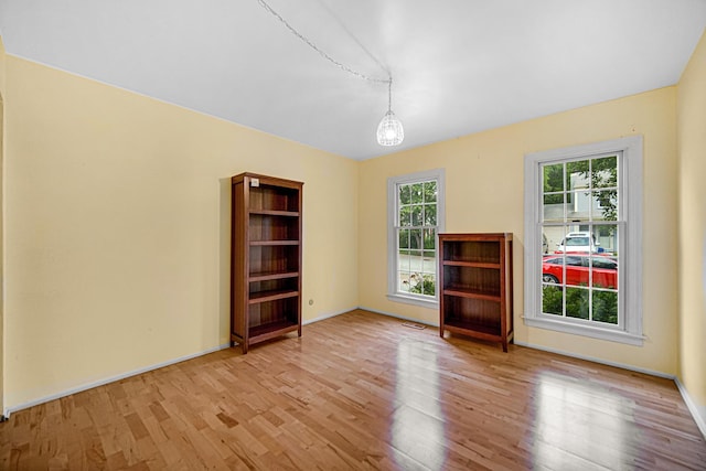 29W409 White Oak Dr, Warrenville, IL 60555 - empty room with wood finished floors and baseboards