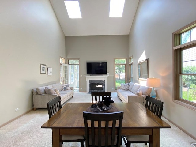 1920 Waverly Cir, Saint Charles, IL 60174 - dining area featuring high vaulted ceiling, light carpet, and a premium fireplace