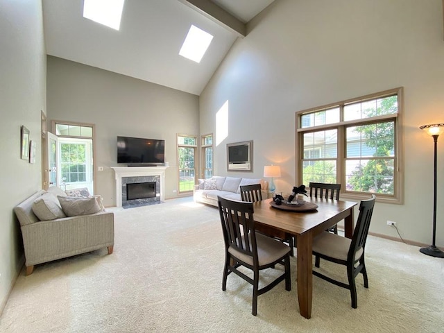 1920 Waverly Cir, Saint Charles, IL 60174 - dining space featuring high vaulted ceiling, light carpet, beamed ceiling, healthy amount of natural light, and a premium fireplace