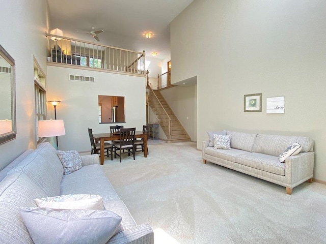 1920 Waverly Cir, Saint Charles, IL 60174 - carpeted living area with stairs, a towering ceiling, and ceiling fan