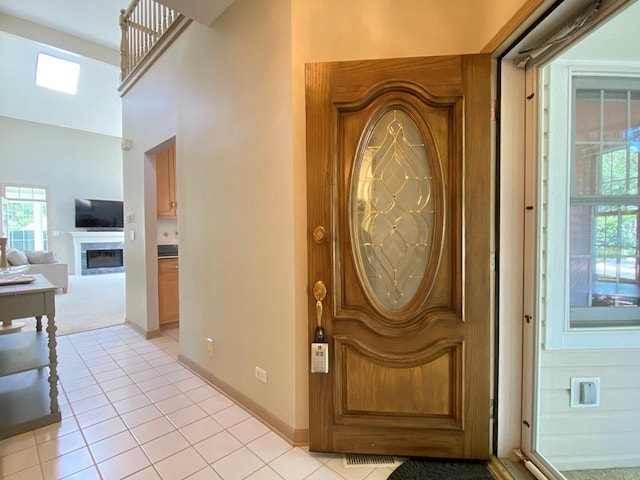 1920 Waverly Cir, Saint Charles, IL 60174 - foyer with light tile patterned flooring, a fireplace, and plenty of natural light