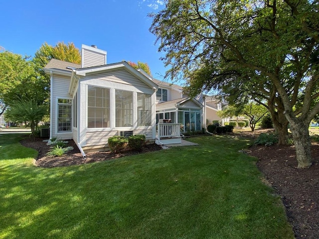 1920 Waverly Cir, Saint Charles, IL 60174 - rear view of property with a sunroom, a chimney, and a lawn